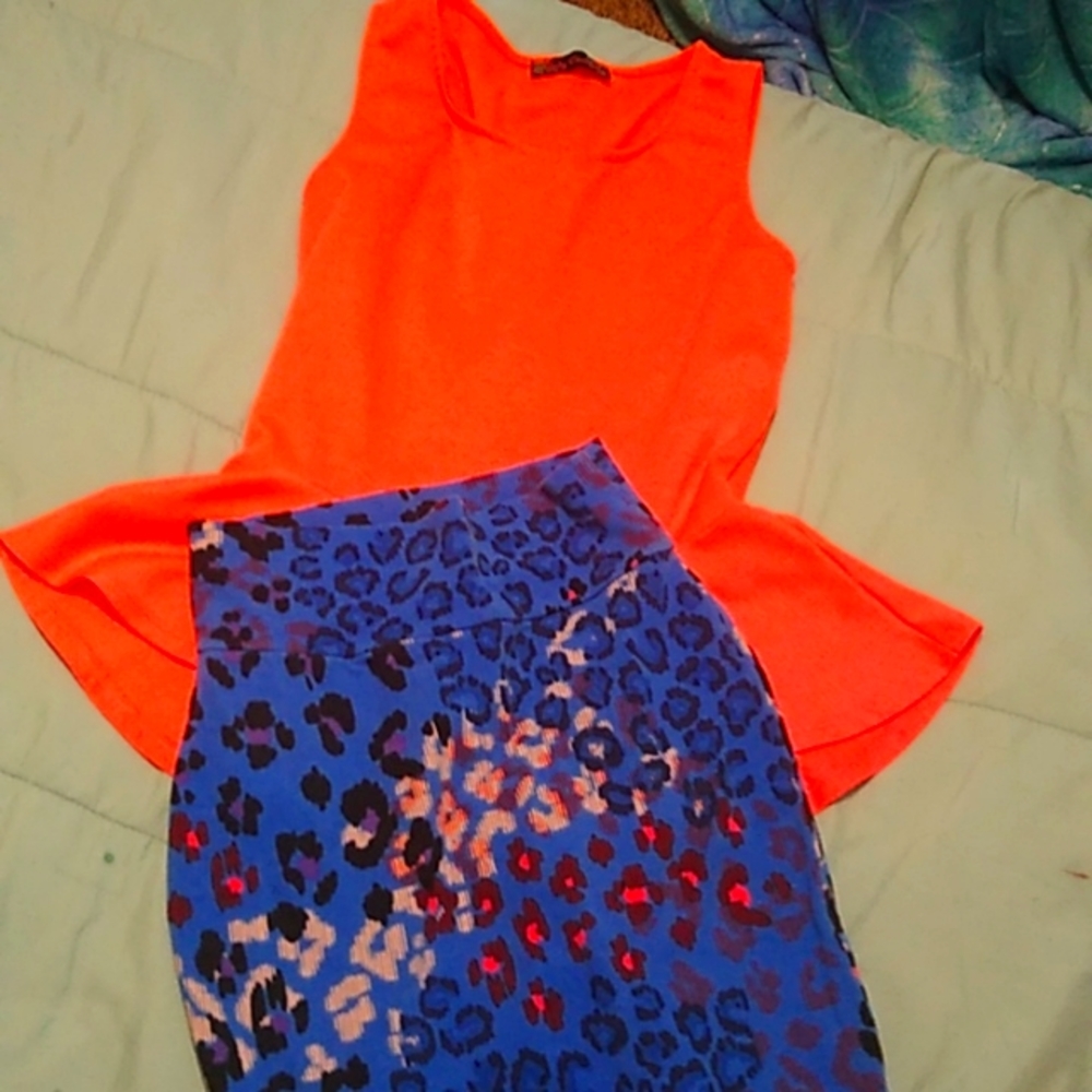 A multi mainly blue skirt with a bright orange sleeve lees top